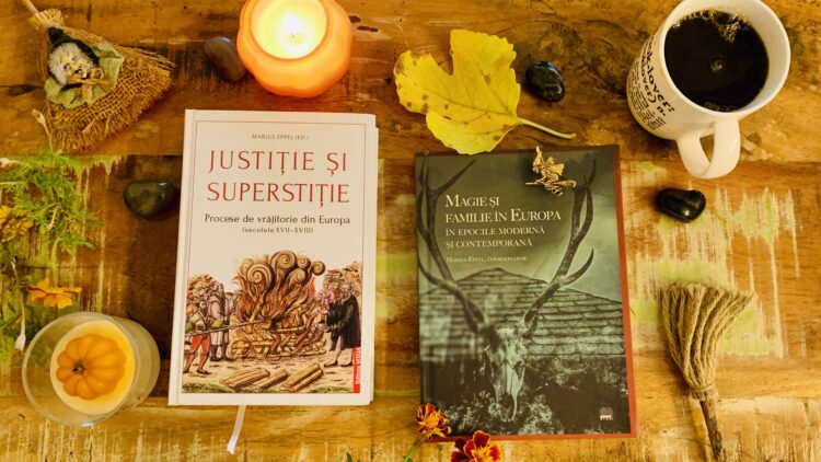 volumele justitie si superstitie si magie si familie in europa pe o masa de lemn inconjurate de obiect decorative de toamna